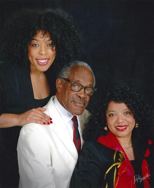 A group of people are posing for a picture together and smiling.
