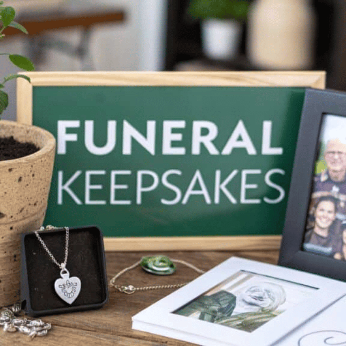 International Funeral Service Southview Trenton NJ - Funeral keepsakes display with a green sign, framed photos, and necklace