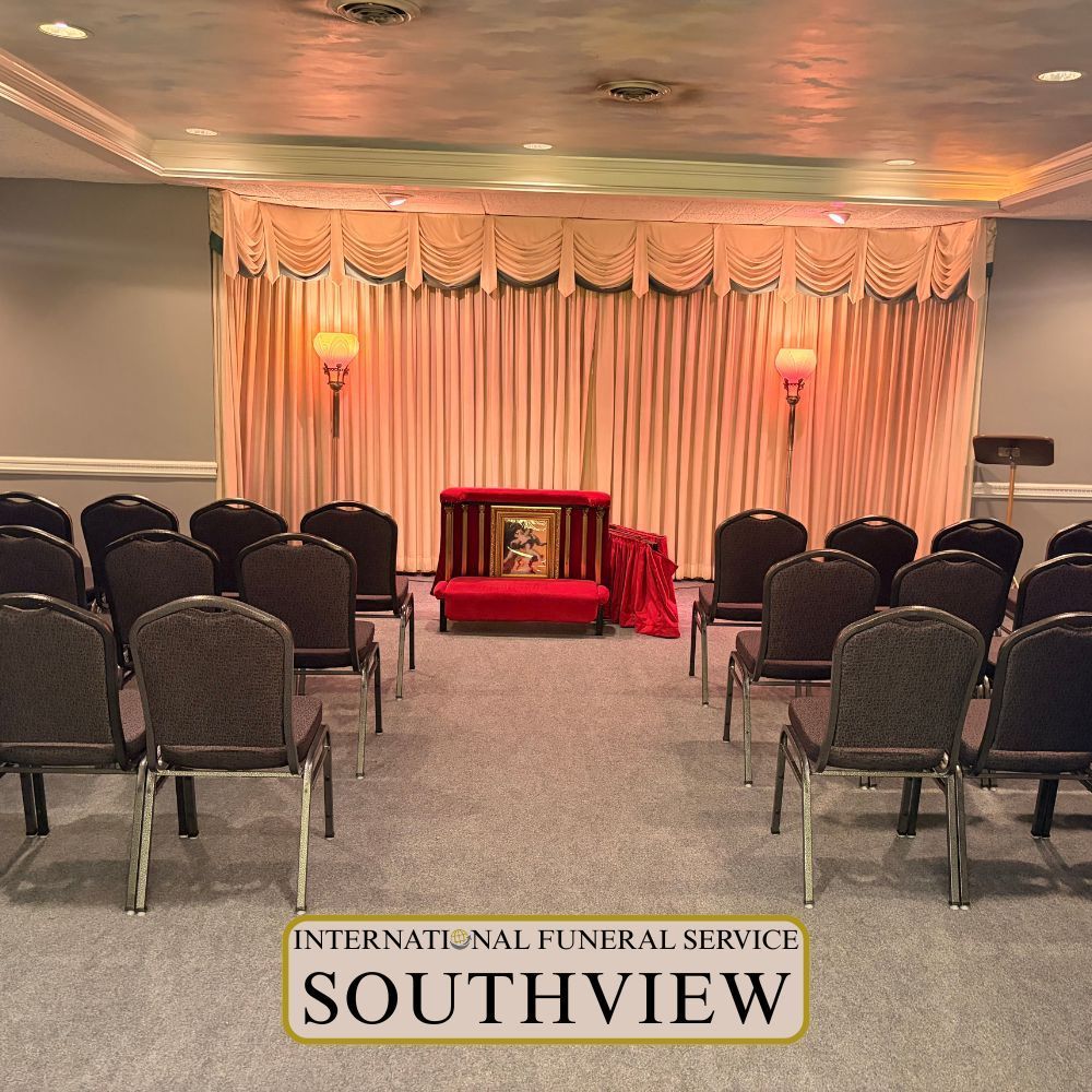 International Funeral Service Southview Trenton NJ - Funeral service viewing room with rows of chairs, a red casket.