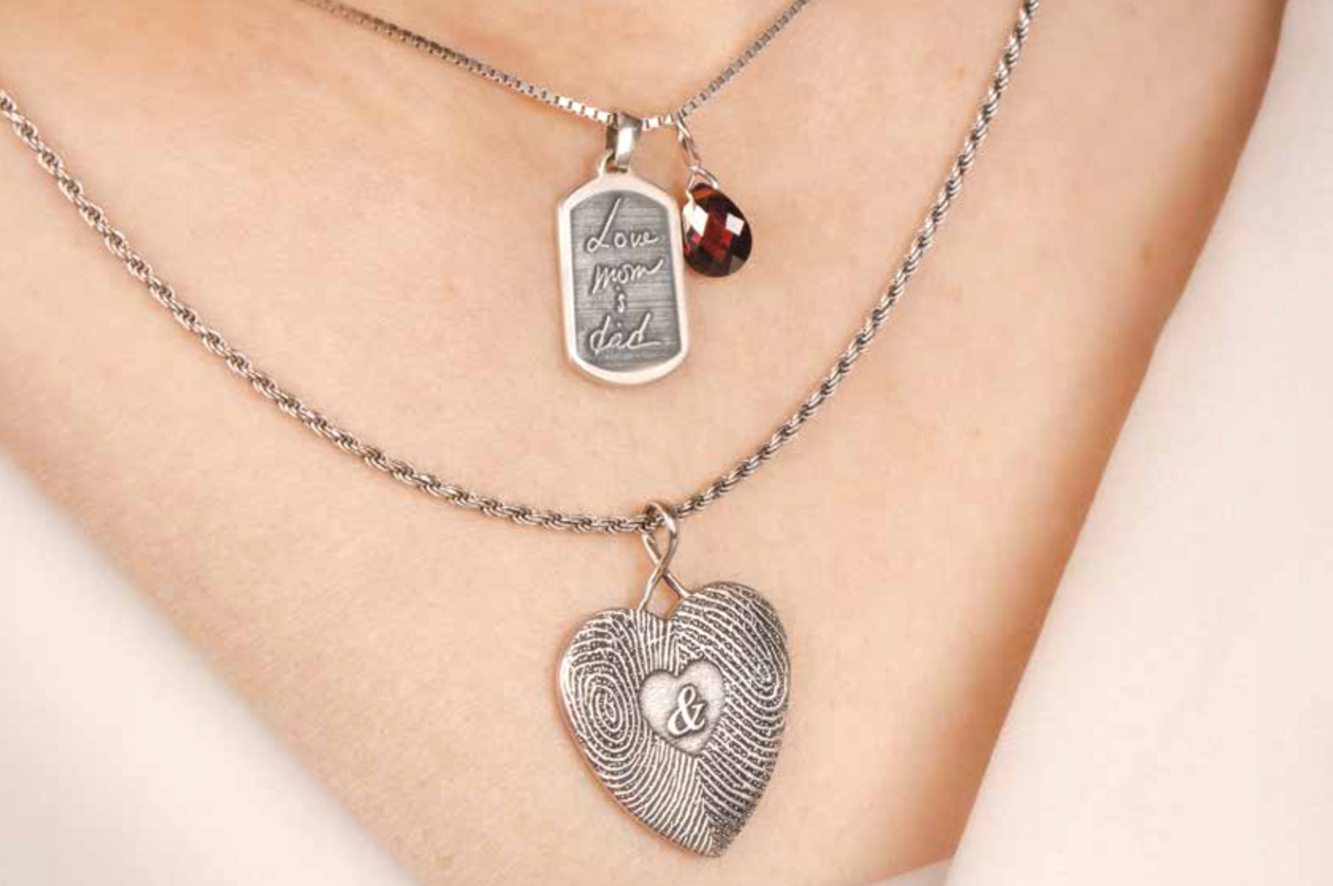 International Funeral Service Southview Trenton NJ - Close-up of layered silver necklaces with a heart pendant.