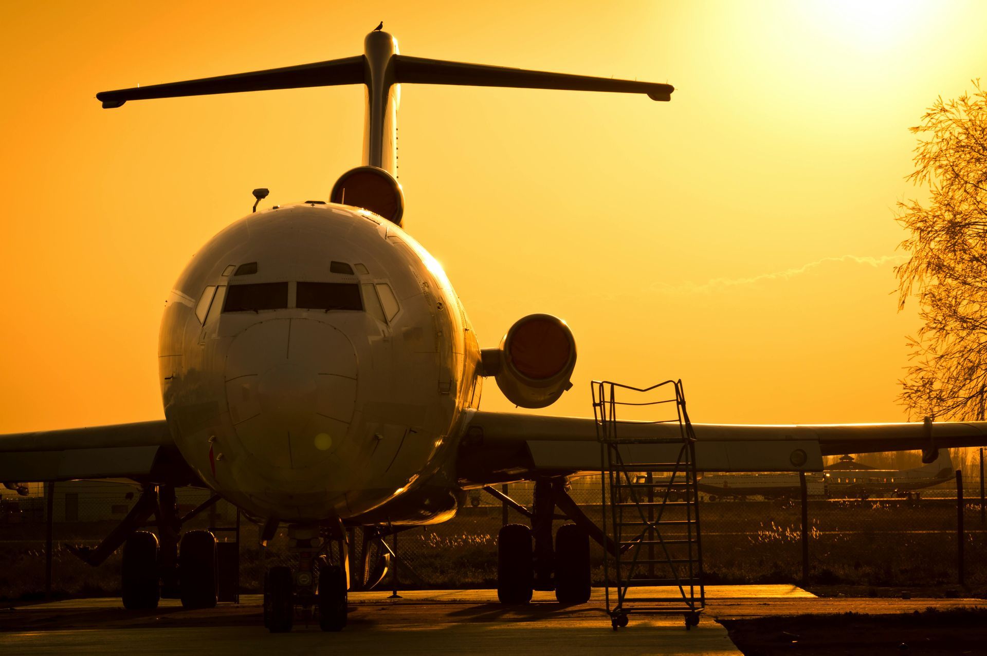 International Funeral Service Southview Trenton NJ - Airplane parked on the tarmac at sunset, silhouetted.