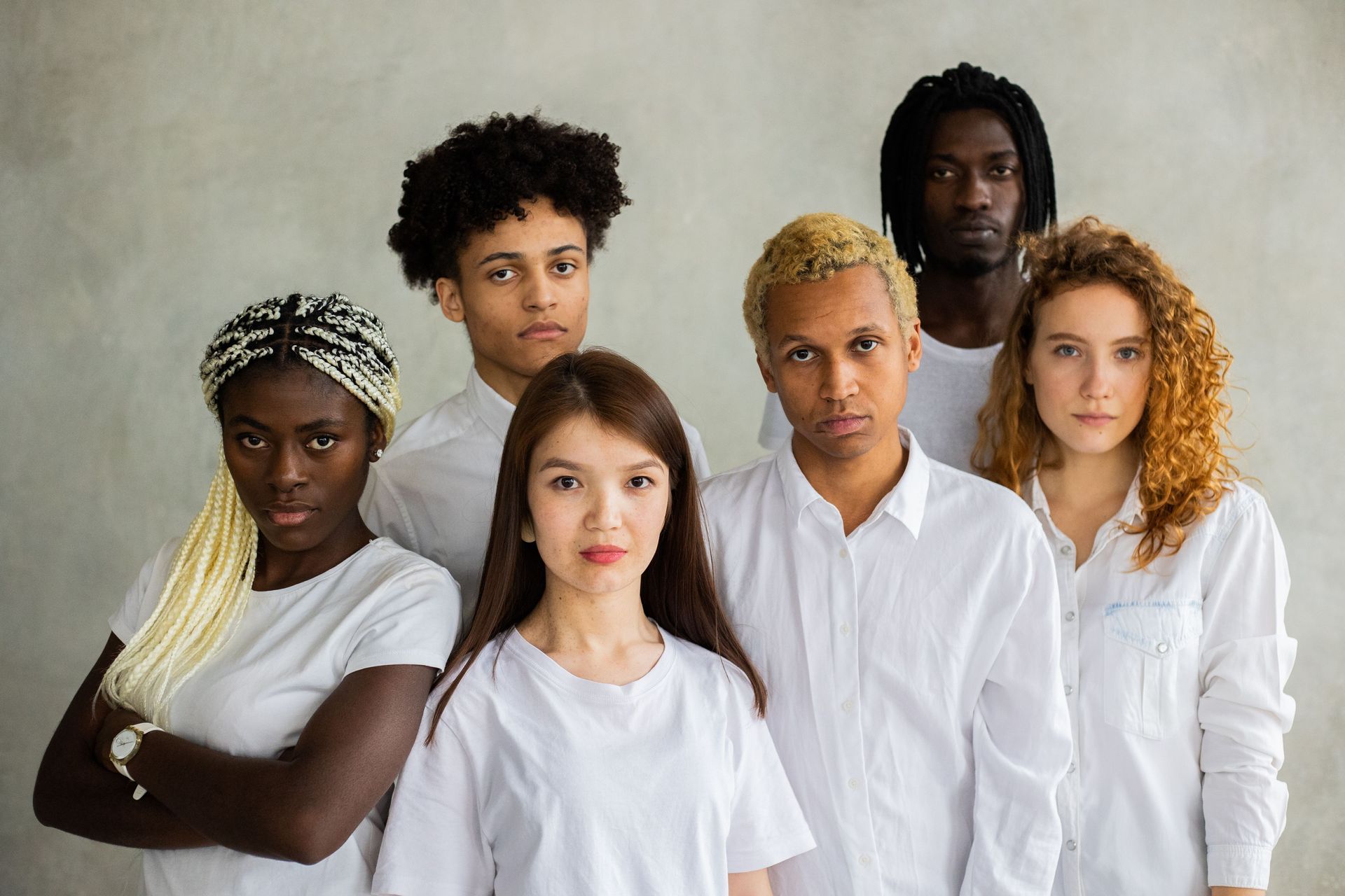 International Funeral Service Southview Trenton NJ - Six people standing together in white shirts against a plain gray back.