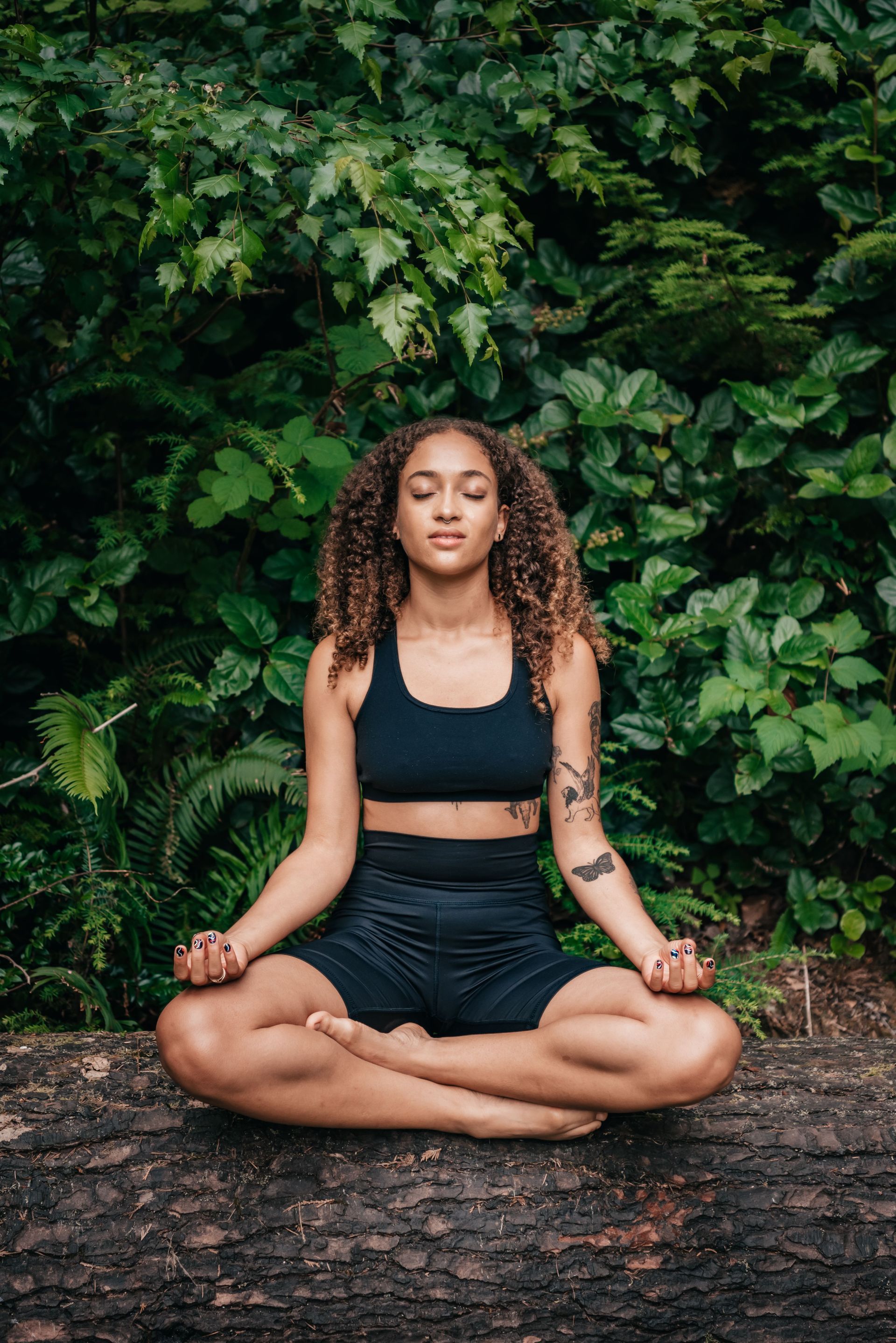 Black woman in nature. African American woman meditating in nature. EMDR Therapy.