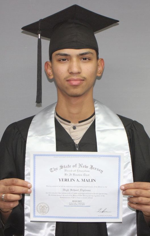 Graduate in cap and gown holding a diploma certificate against a plain background