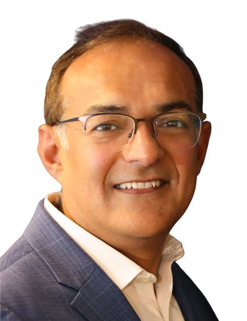 Portrait of a smiling man wearing glasses and a blue blazer on a white background