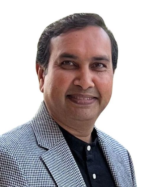 Smiling man in a gray checkered blazer and black shirt against a white background