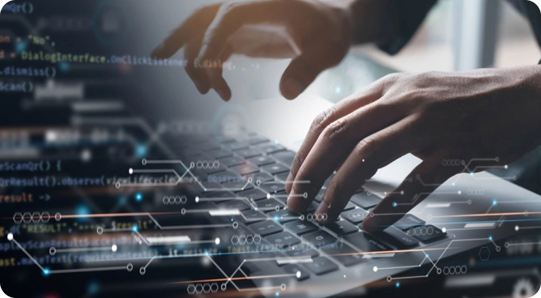 Hands typing on a laptop with digital code and network graphics overlayed on the screen