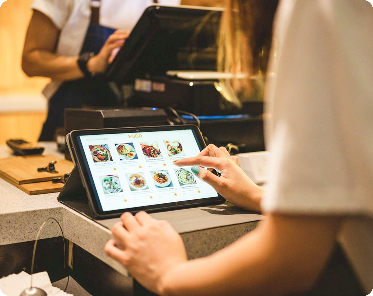 Person using a tablet to browse food menu at a café counter