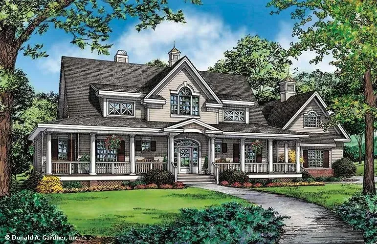 Two-story house with wrap-around porch, gray roof, and landscaped yard.