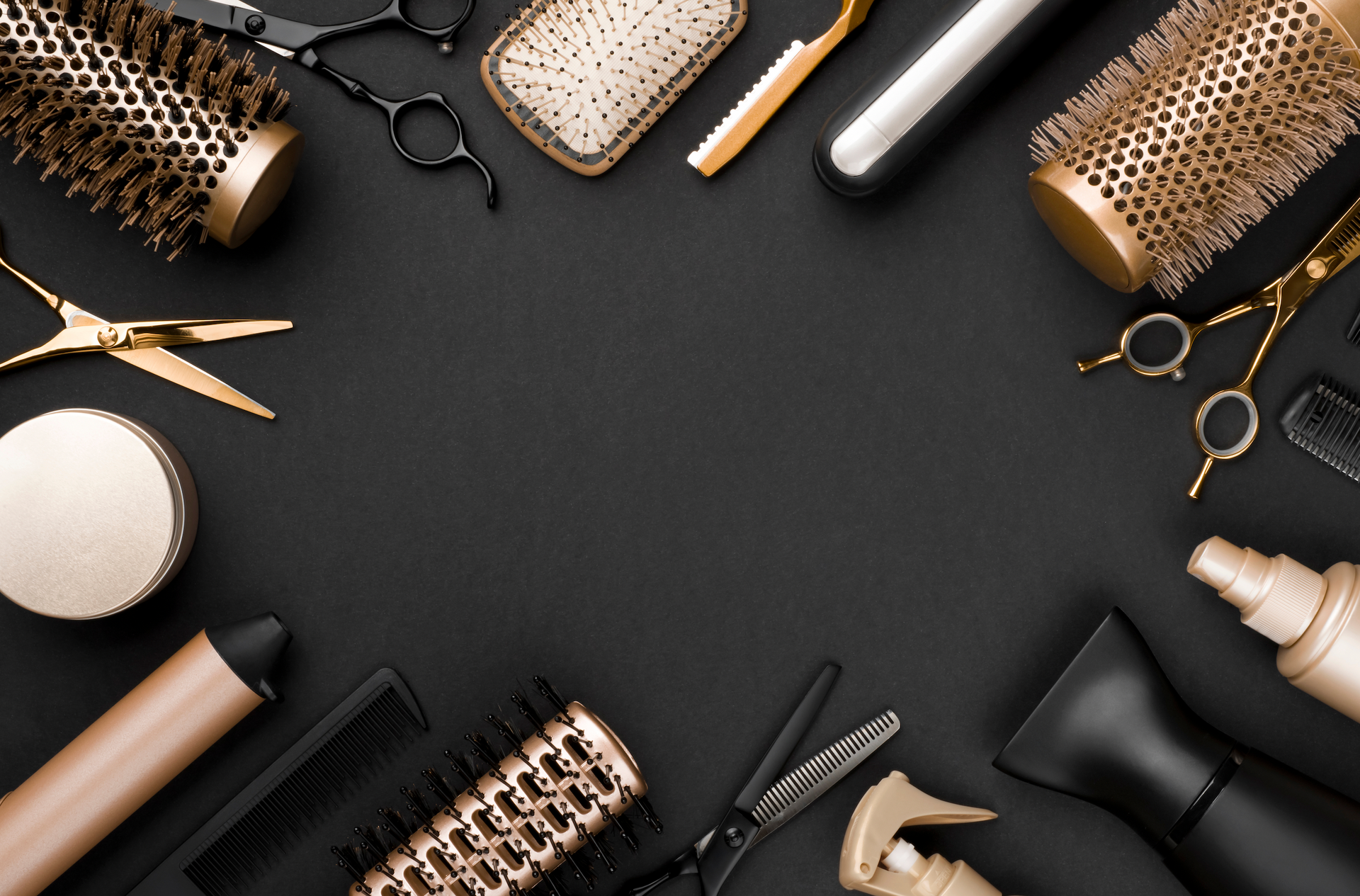 A bunch of hair brushes and scissors on a black background