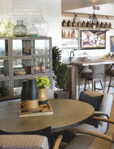Cozy café interior with round table, chairs, glass cabinet, bar shelves, and counter seating