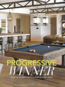 Modern open-plan room with pool table and kitchen, overlaid with the text “PROGRESSIVE WINNER”