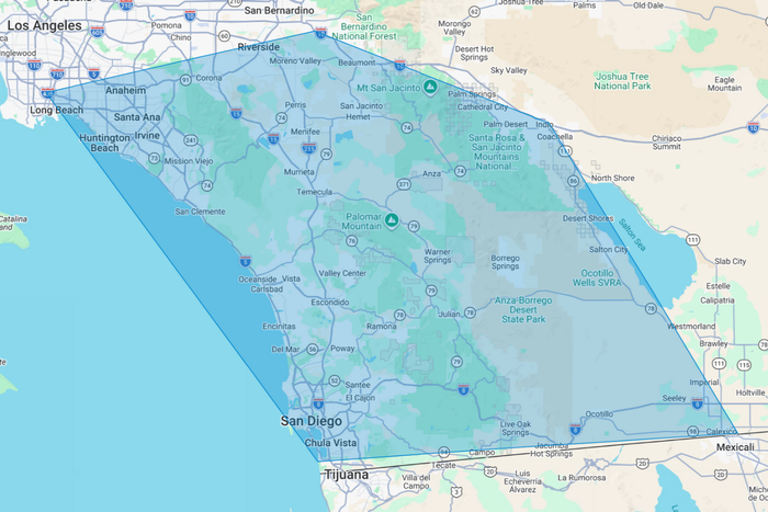 Blue shaded map showing a coastal region with roads, towns, and boundaries