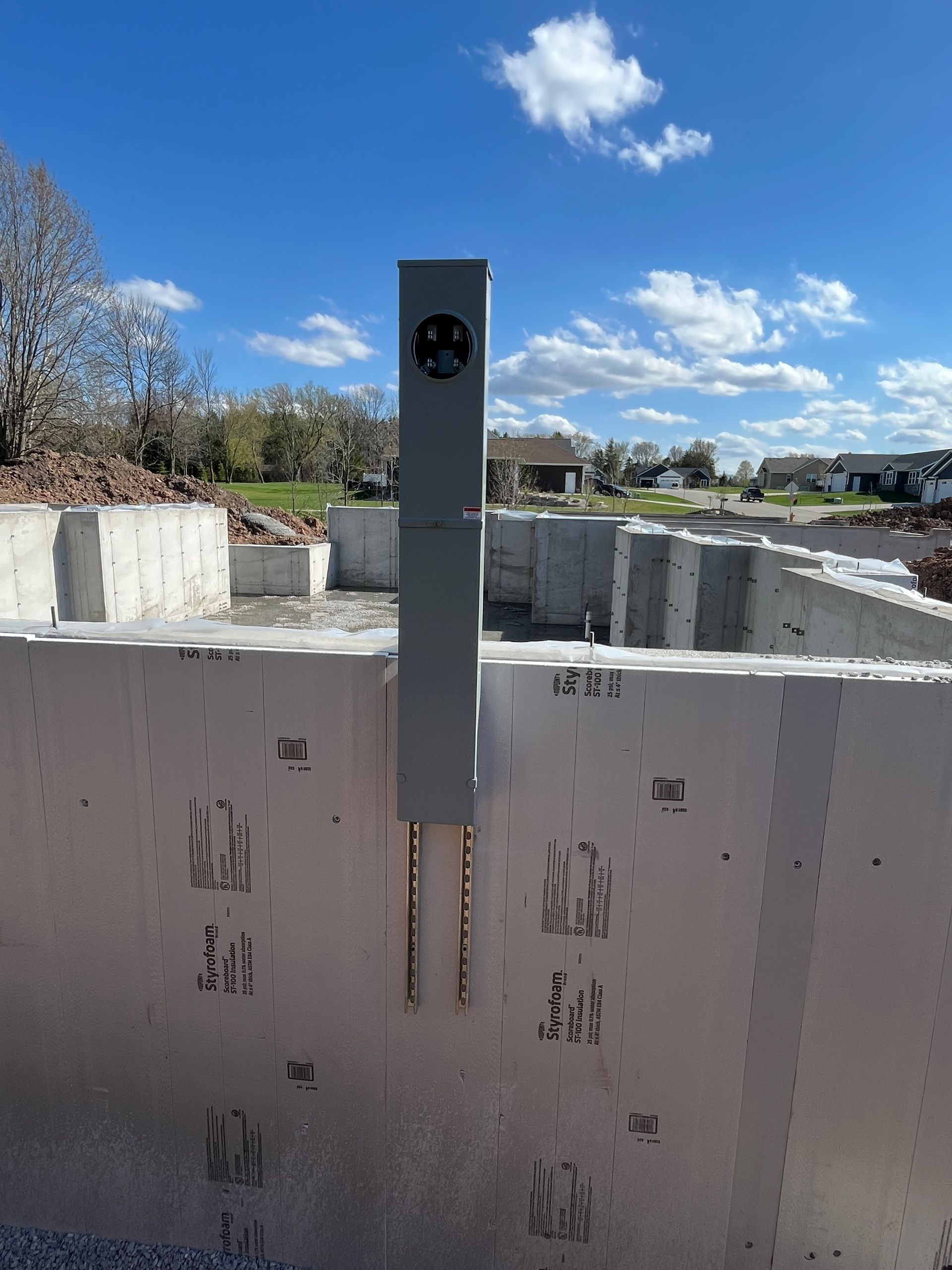 A concrete wall with a electrical box attached to it installed by Patriot Electrical Solutions.