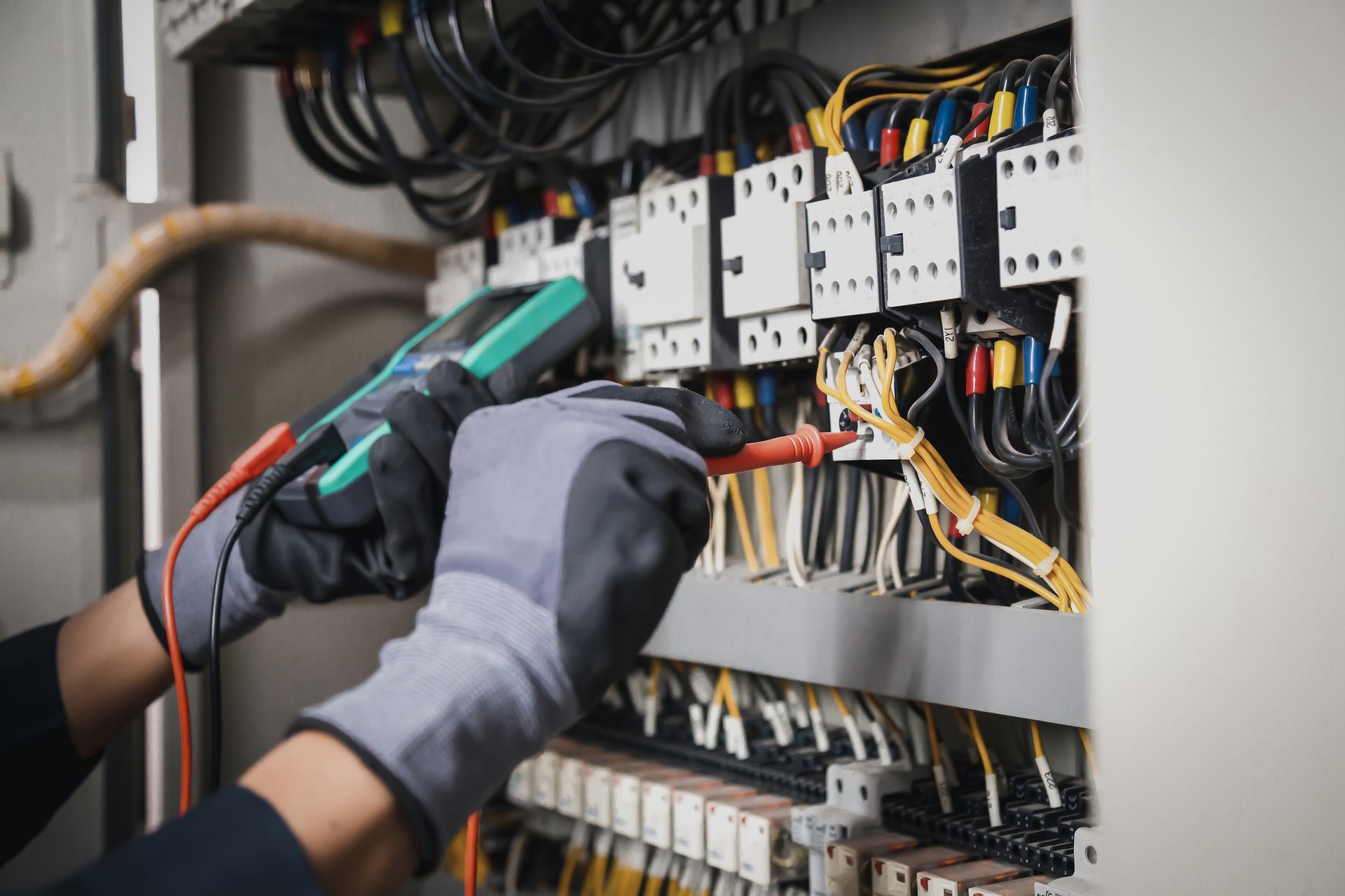 Appleton Wisconsin home in winter and electrician inspecting electrical panel indoors.