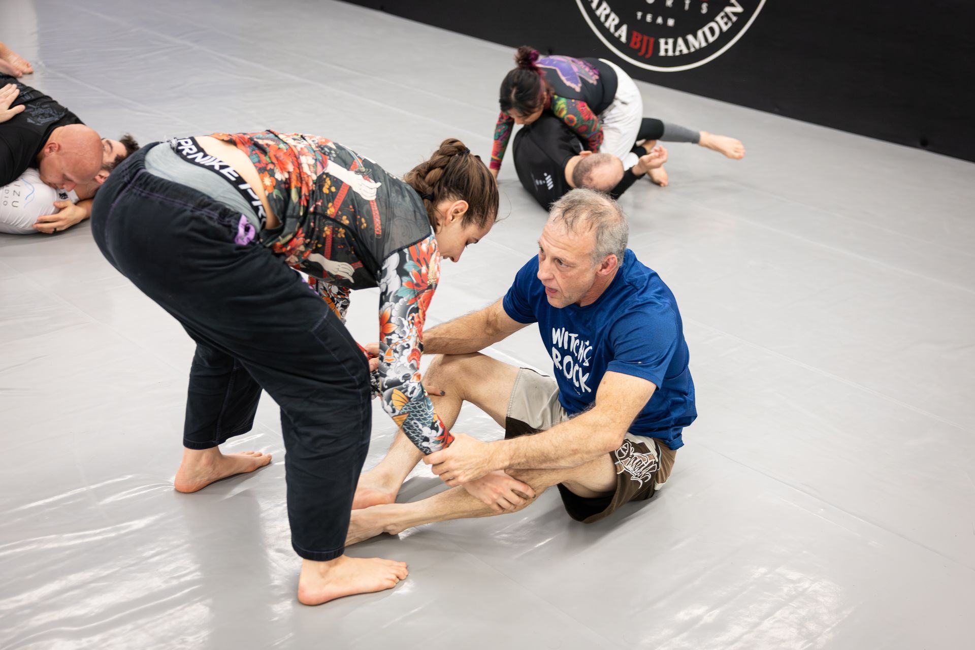 Adults drilling Brazilian Jiu Jitsu techniques at Soulcraft Martial Arts in Hamden, CT to build calm focus.