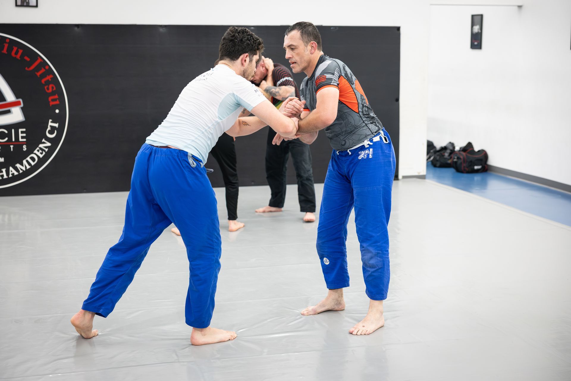 Adult students practicing Muay Thai pad drills at Soulcraft Martial Arts in Hamden, CT for strength.