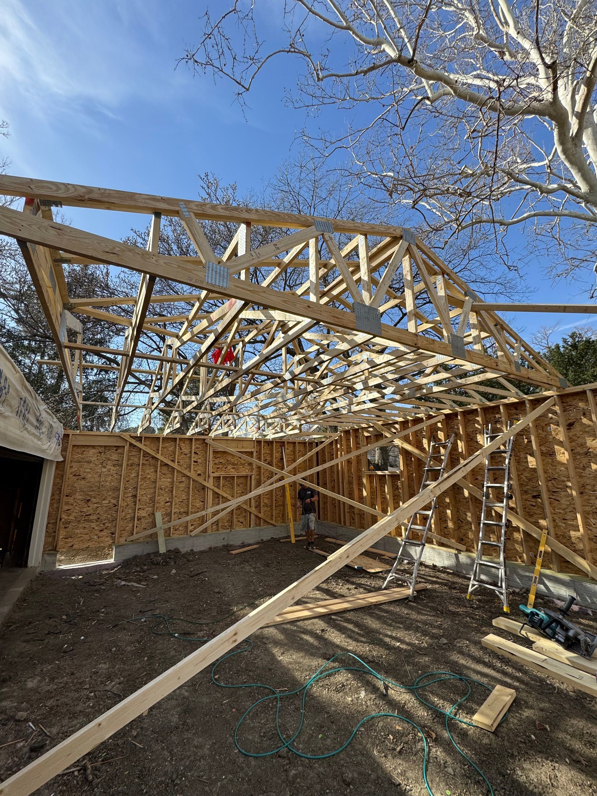 A house is being built with a lot of wooden beams.