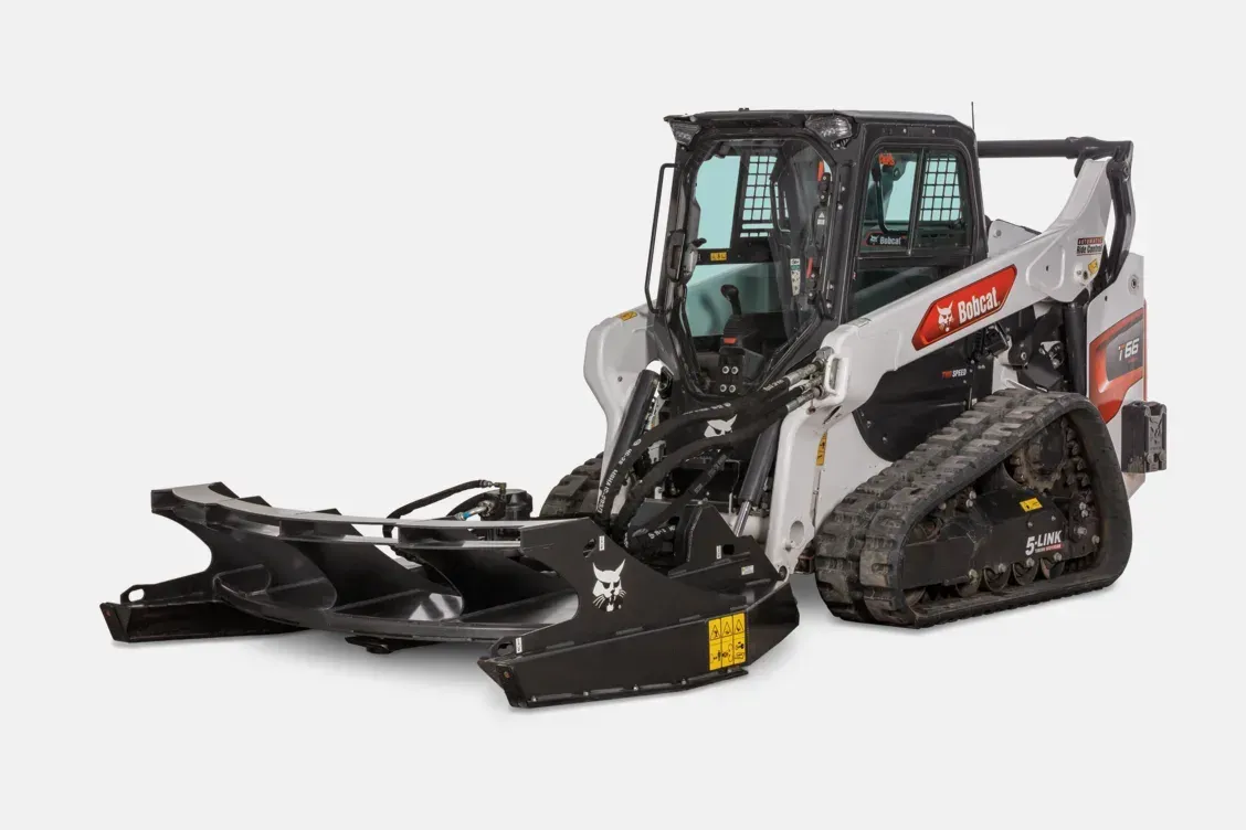Compact track loader with front snowplow attachment on a white background