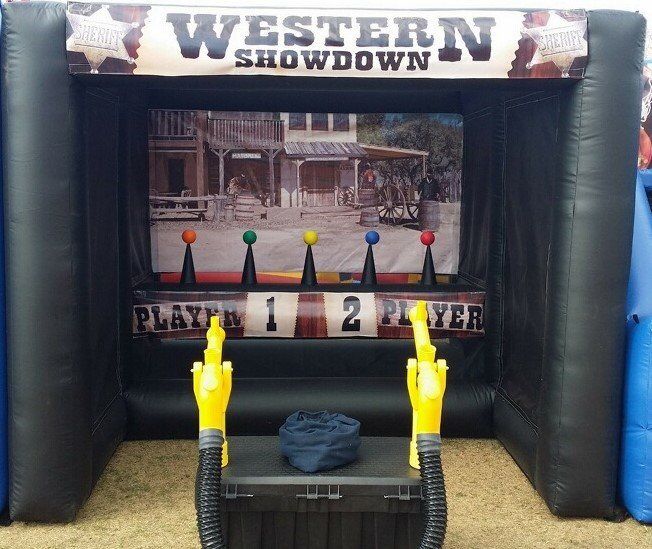 Western Showdown carnival game booth with targets and yellow gun controllers in front