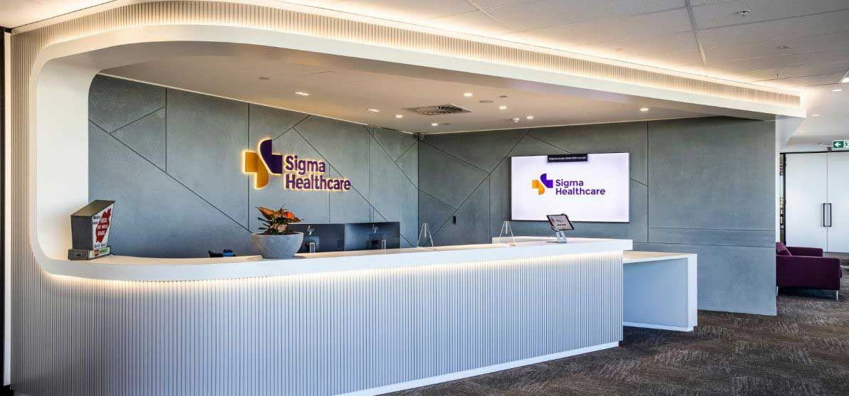 A Reception Desk In A Hospital With A Large Screen On The Wall