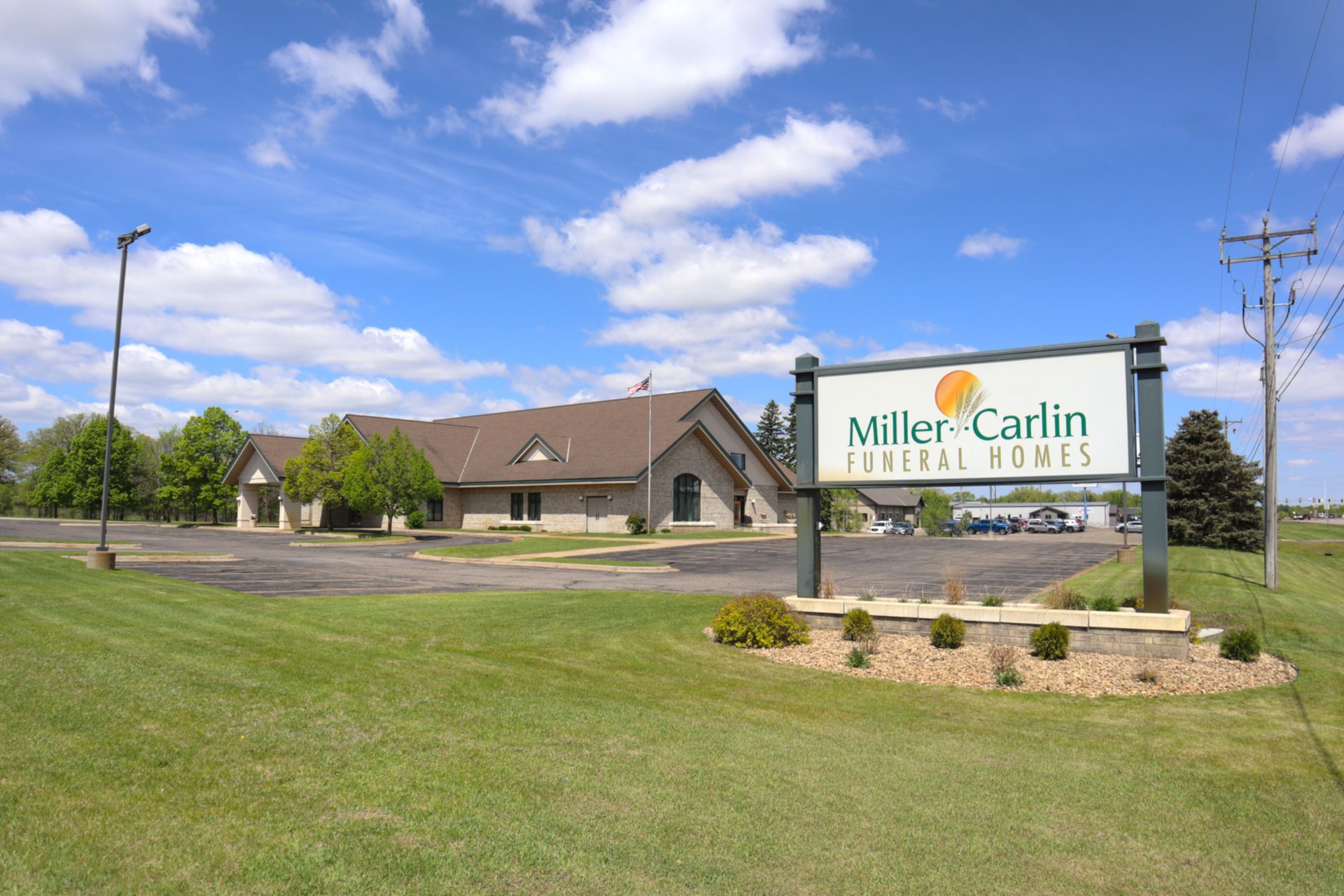 A large white building with a sign in front of it.