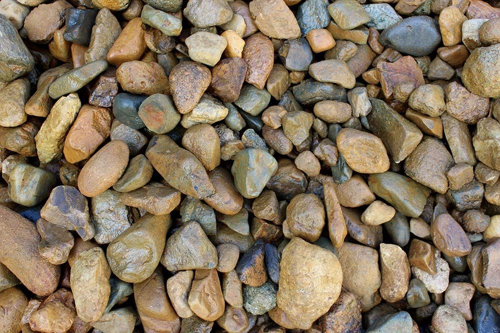 A Pile of River Rocks Gravel on the Ground — Caloundra Landscape Supplies in Caloundra, QLD
