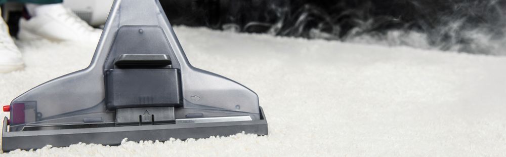 A Carpet Cleaner Head Moving Over a White Carpet — NQW Services In Cloncurry, QLD