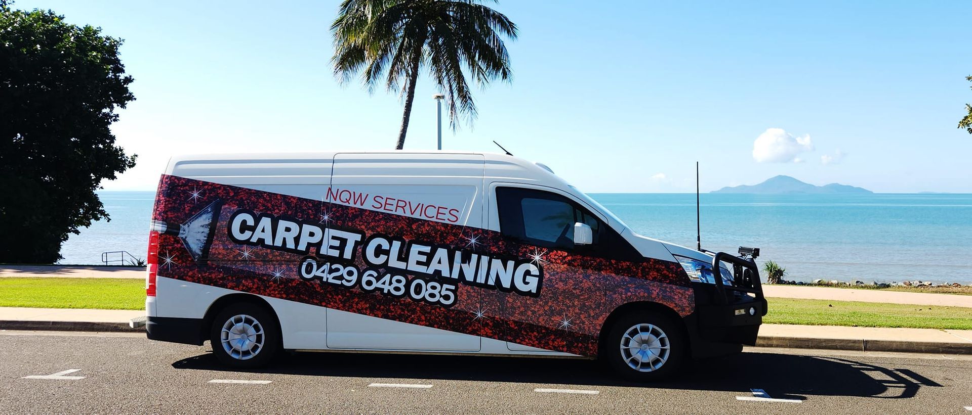 A Carpet Cleaning Van is Parked on the Side of the Road — NQW Services In Cardwell, QLD