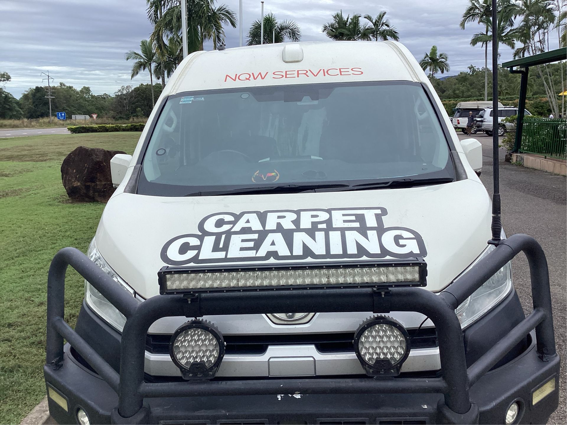 A Carpet Cleaning Van is Parked in Front of a Building — NQW Services In Cardwell, QLD
