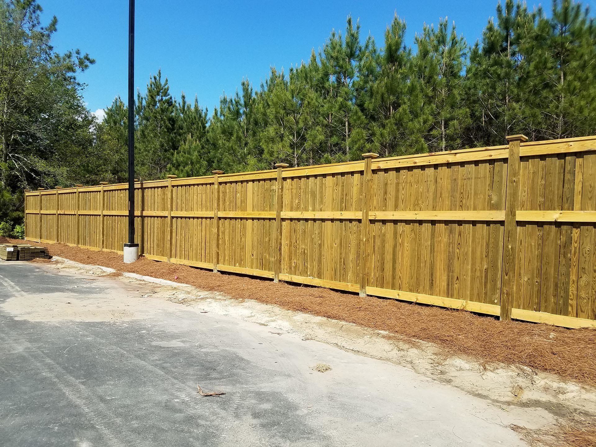 Wooden Fence With Lamp Post — Wilmington,  NC — J & J Fence