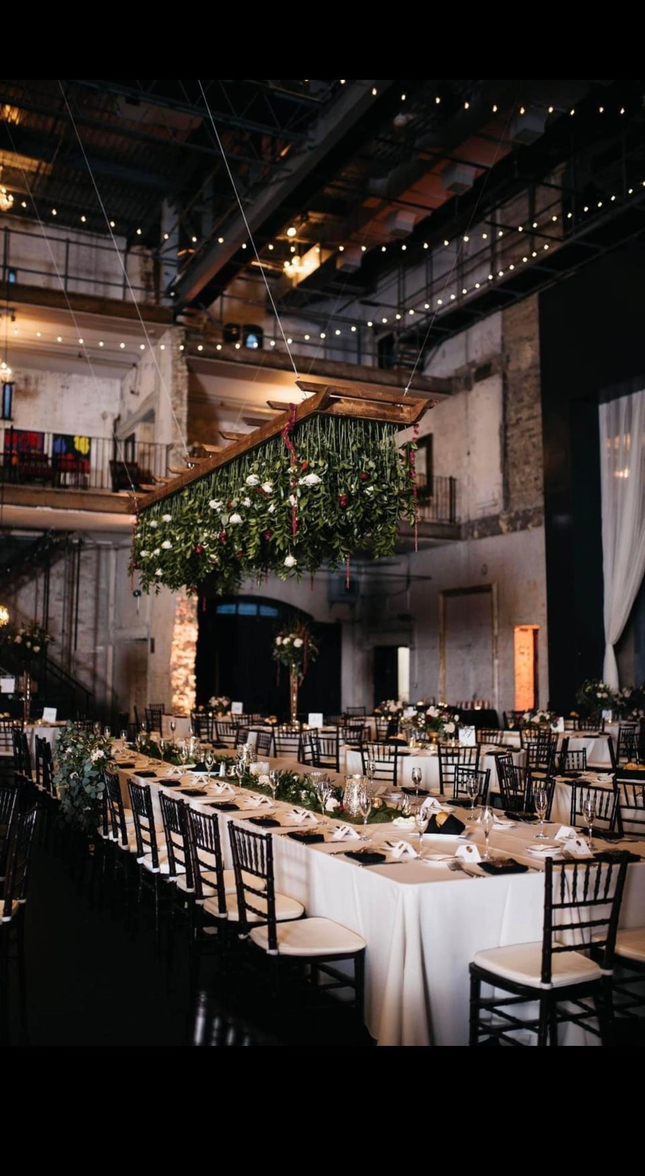 A bunch of white flowers are hanging from the ceiling.