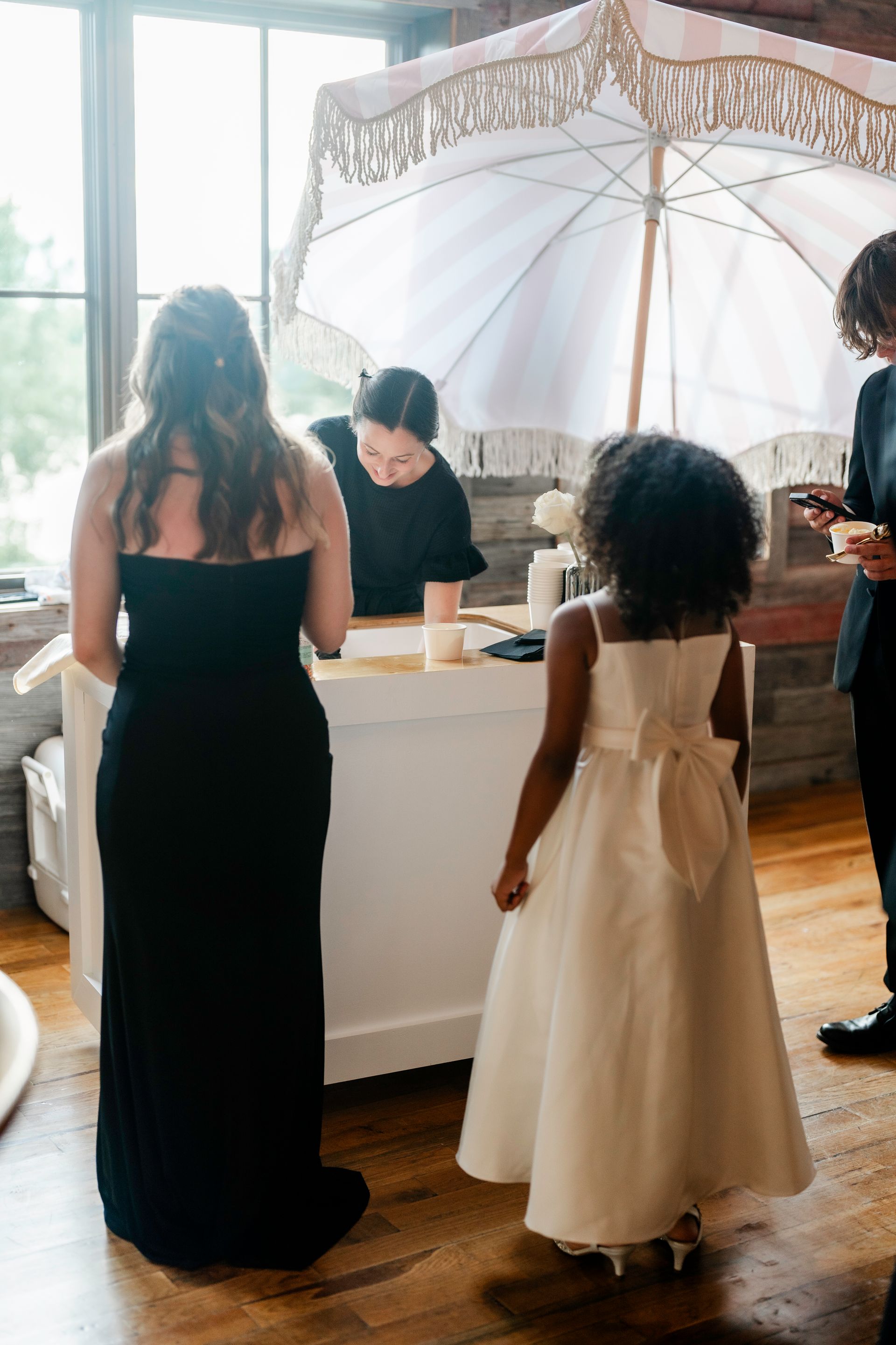 A white umbrella is sitting on top of a white table in a room.