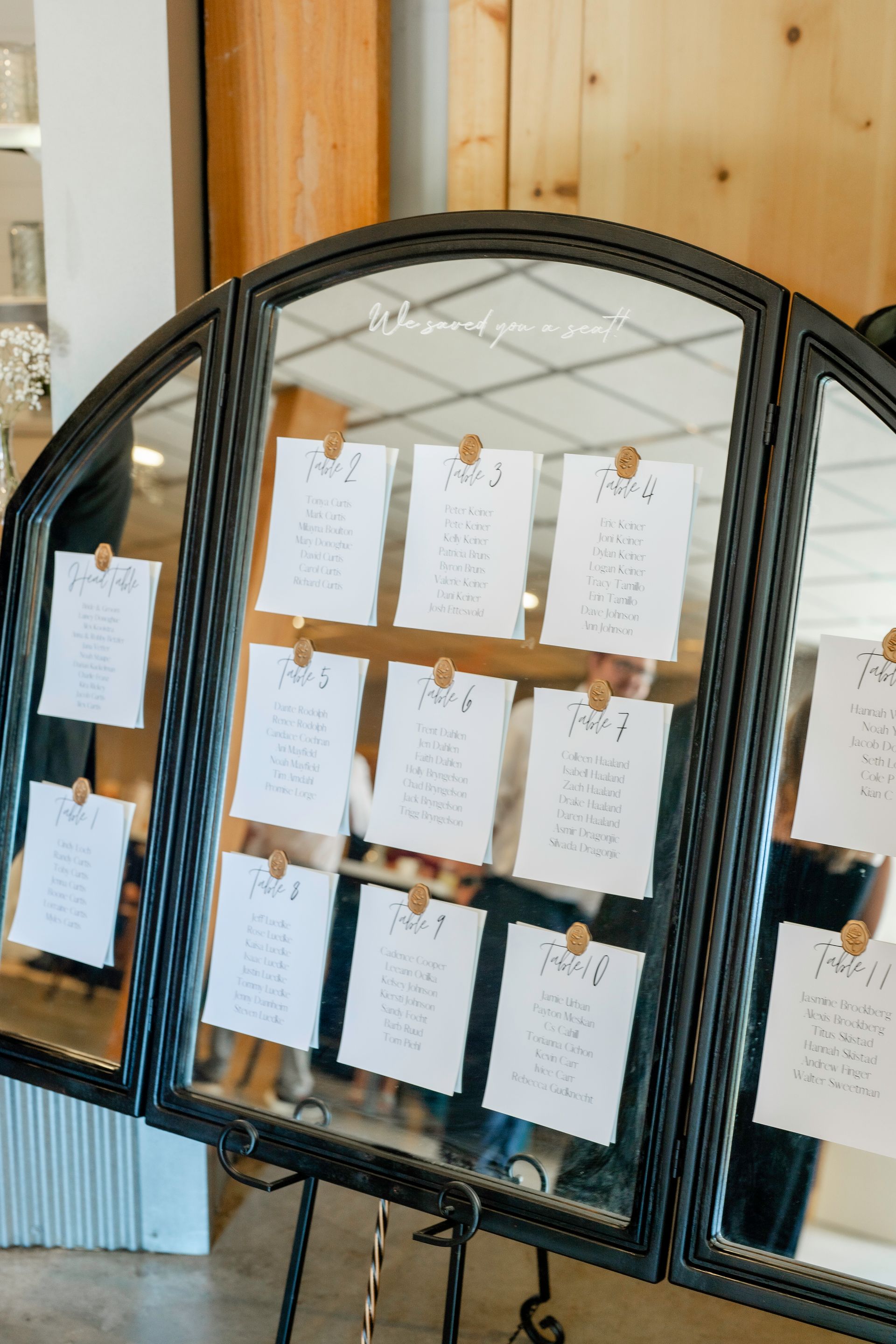 A table plan is displayed in front of a mirror.