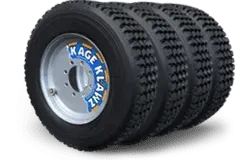 Four black skid steer tires stacked, each with a silver wheel featuring