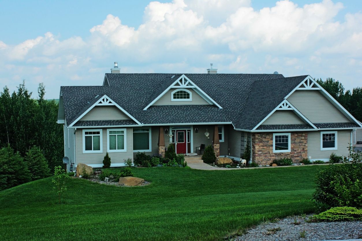 A large house with a large lawn in front of it