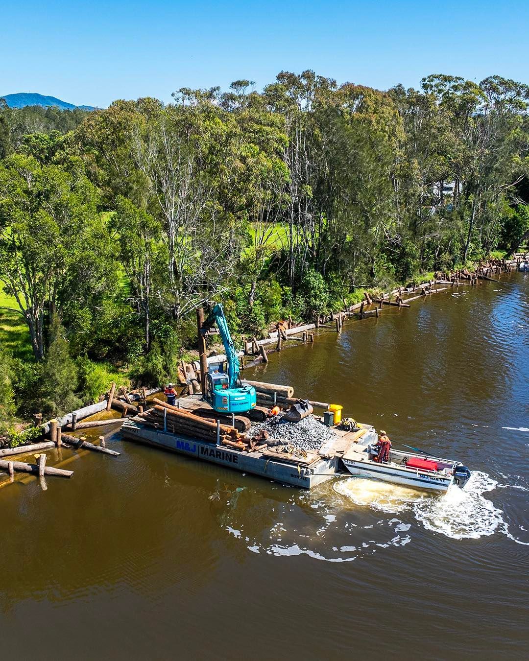 An Excavator on A Barge Collects Logs from A River — M&J Marine Services in Lake Macquarie, NSW