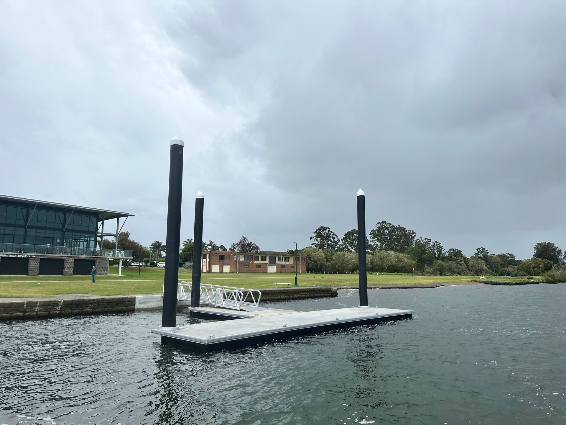 A Floating Boat Dock Anchored by Three Tall Black Pylons — M&J Marine Services in Lake Macquarie, NSW