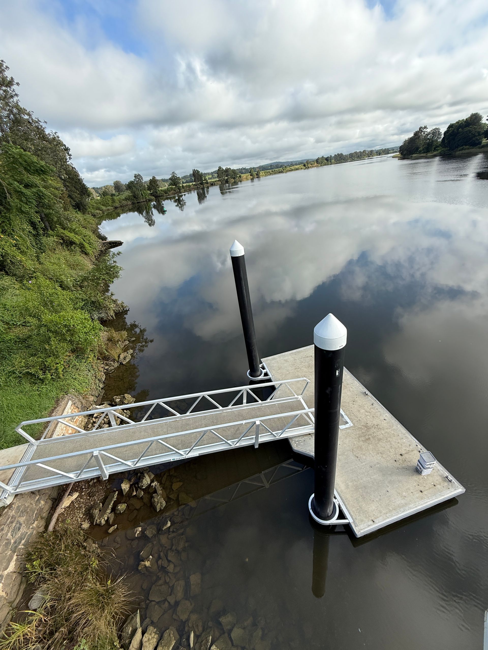 A Floating Metal Dock and Access Ramp Extend Into a Calm River — M&J Marine Services in Coffs Harbour, NSW
