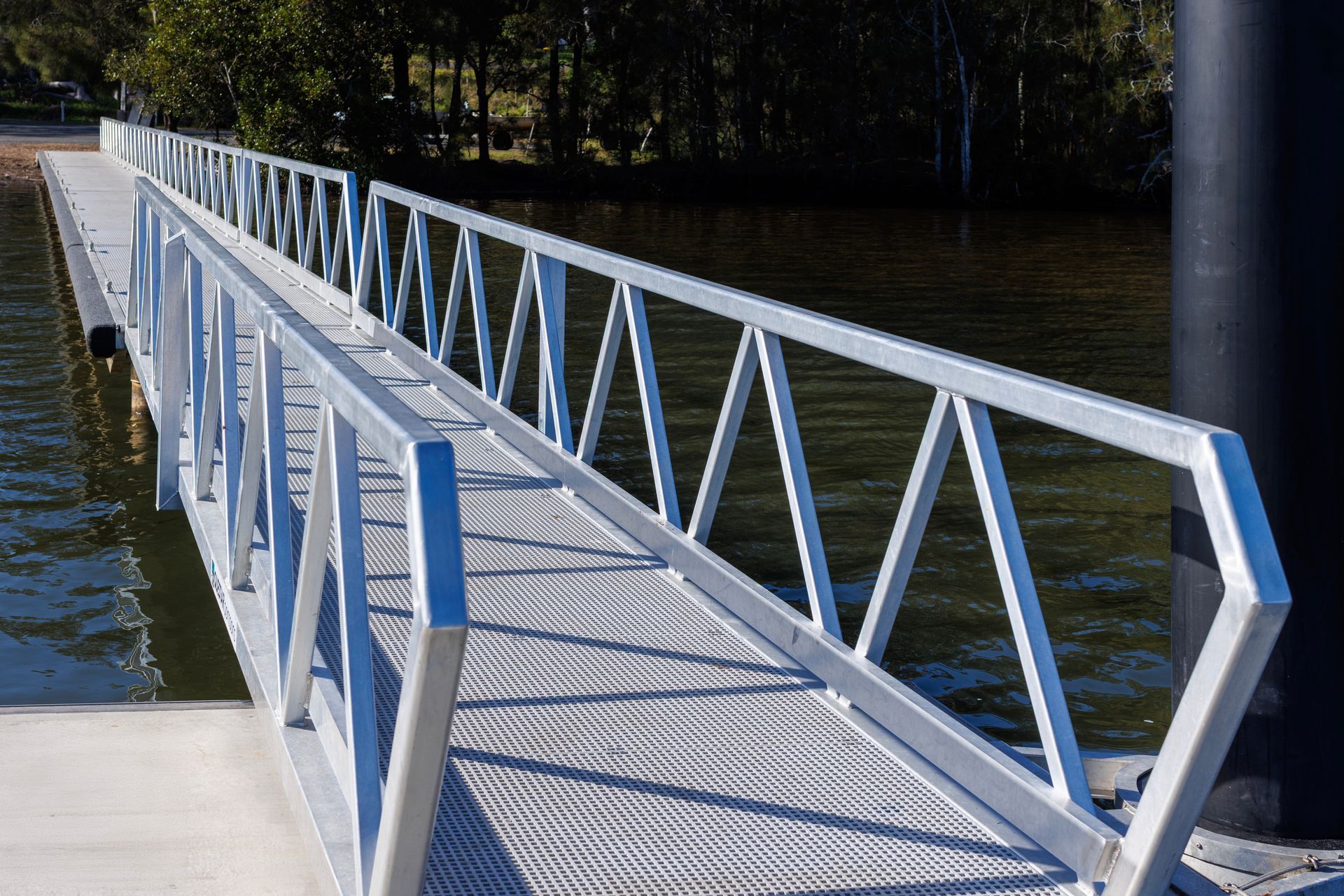 A Metal Pedestrian Ramp with A Triangular Truss Railing — M&J Marine Services in Newcastle, NSW