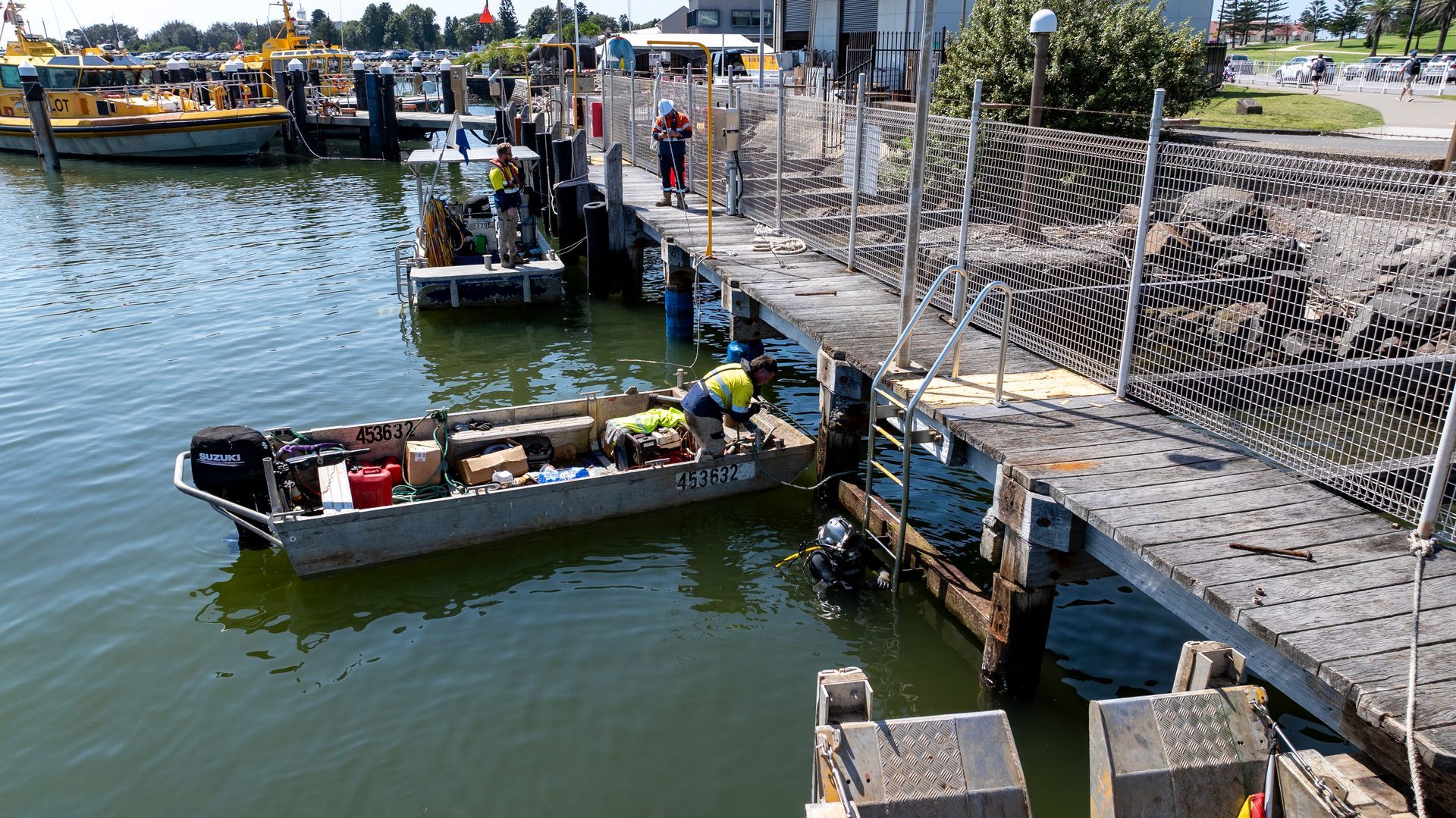 Workers in High-Visibility Gear Work — M&J Marine Services in Forster, NSW