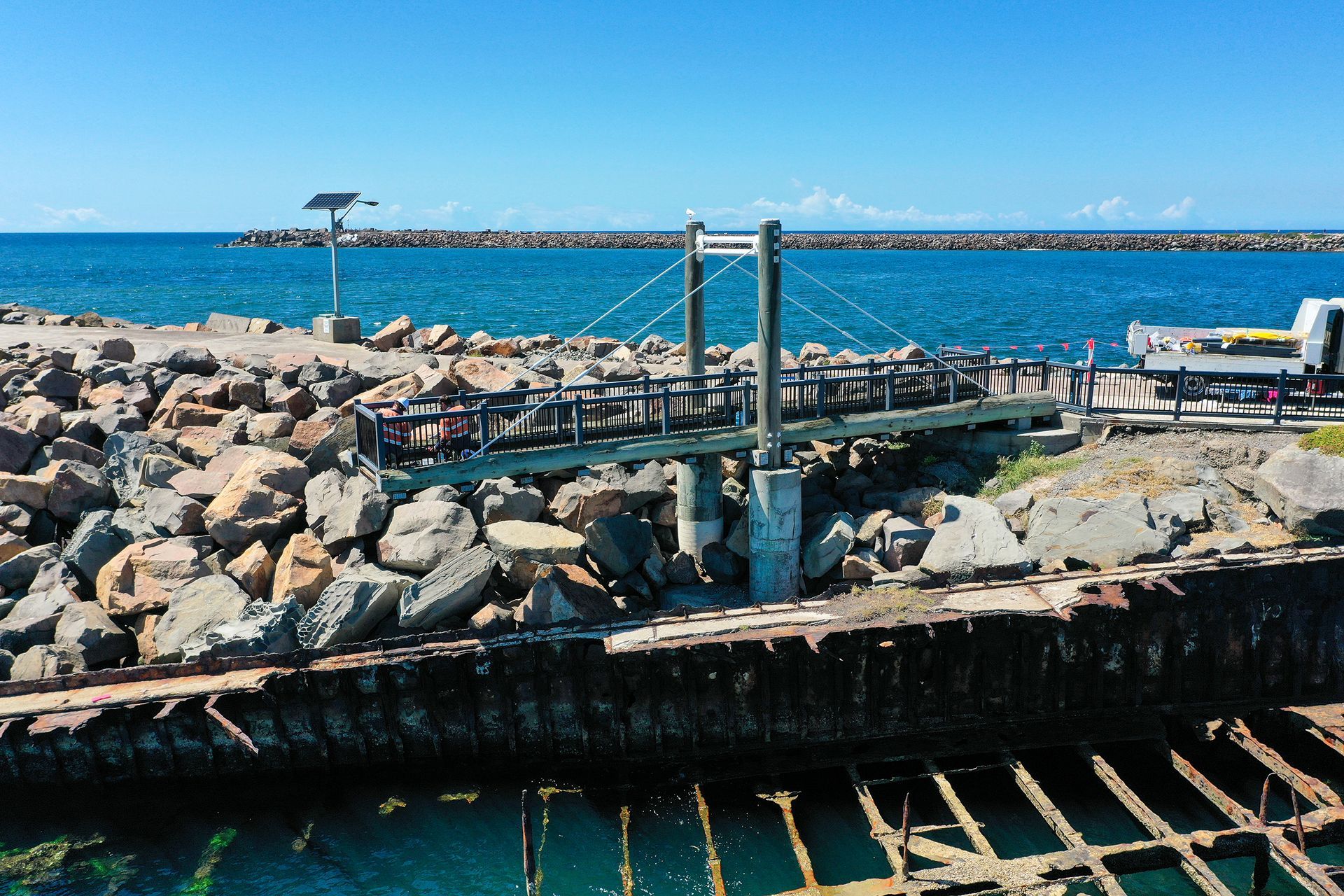 A Small Pedestrian Bridge with A Metal Frame Spans a Gap — M&J Marine Services in Newcastle, NSW