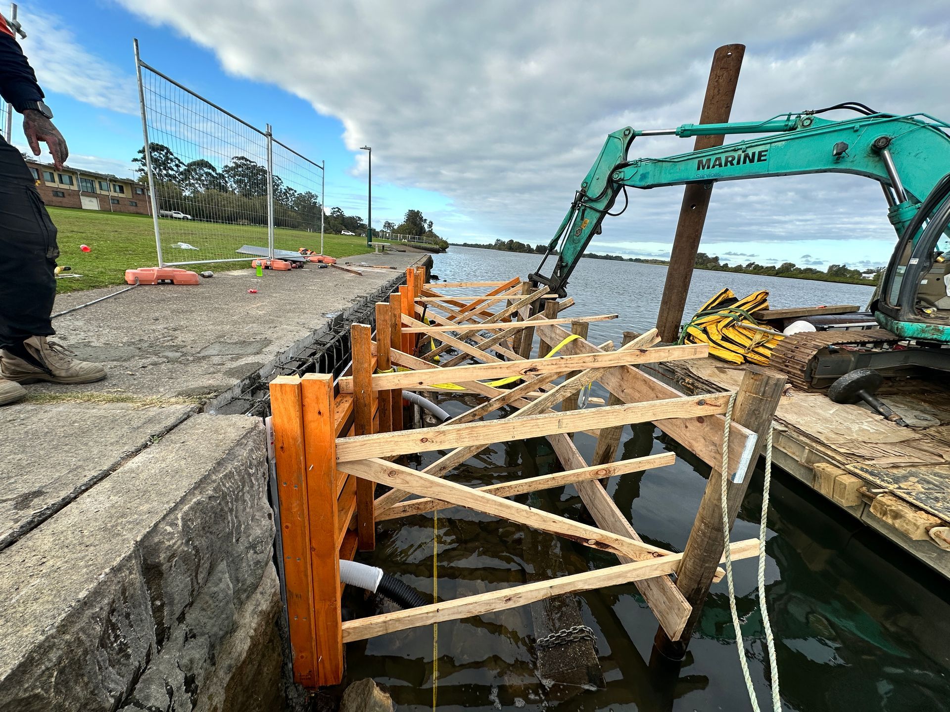 An Excavator on A Barge Installs Wooden Framing for A Pier Extension — M&J Marine Services in Forster, NSW