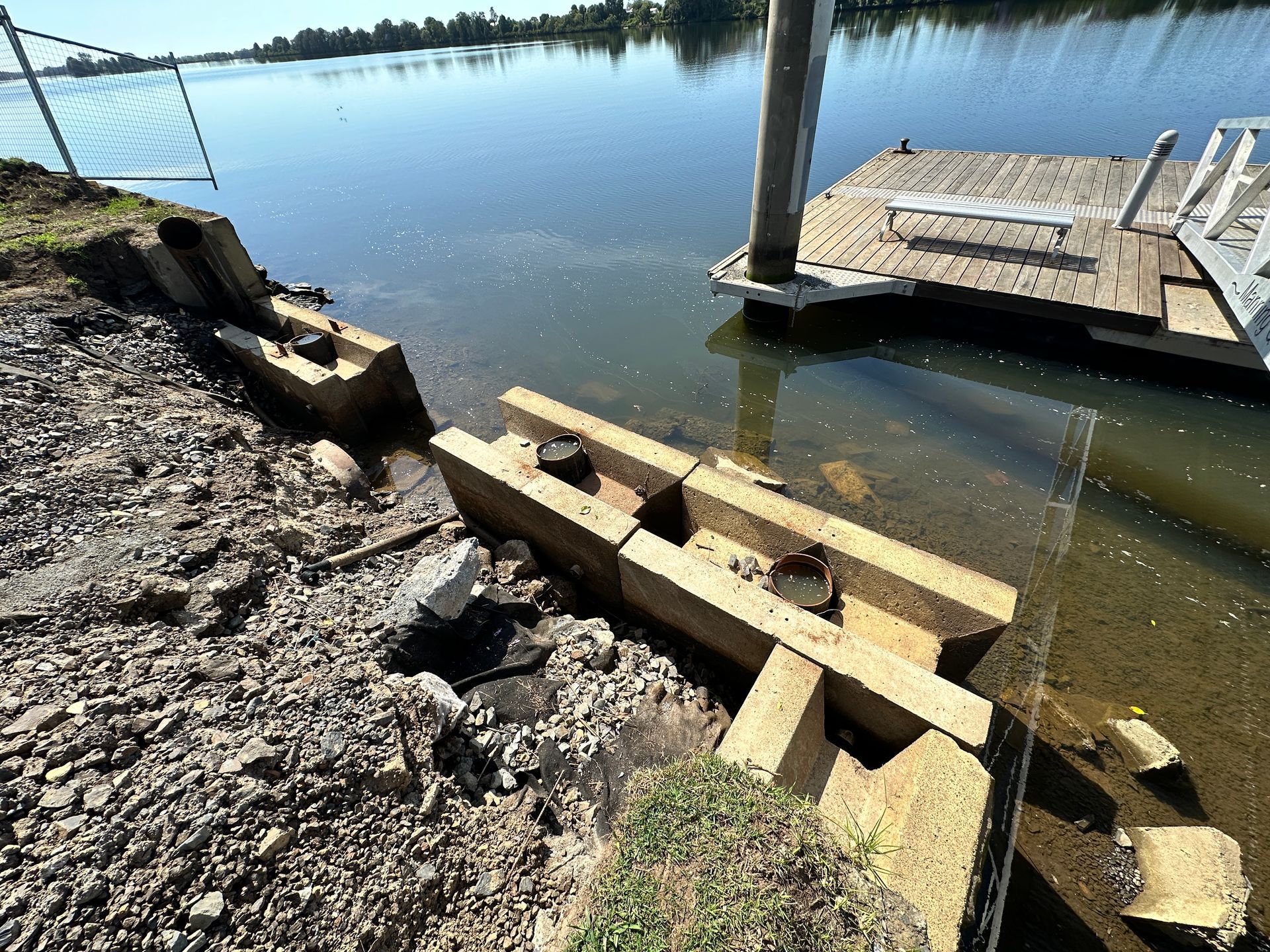 Concrete Retaining Wall Blocks Lining a Rocky Shoreline — M&J Marine Services in Lake Macquarie, NSW