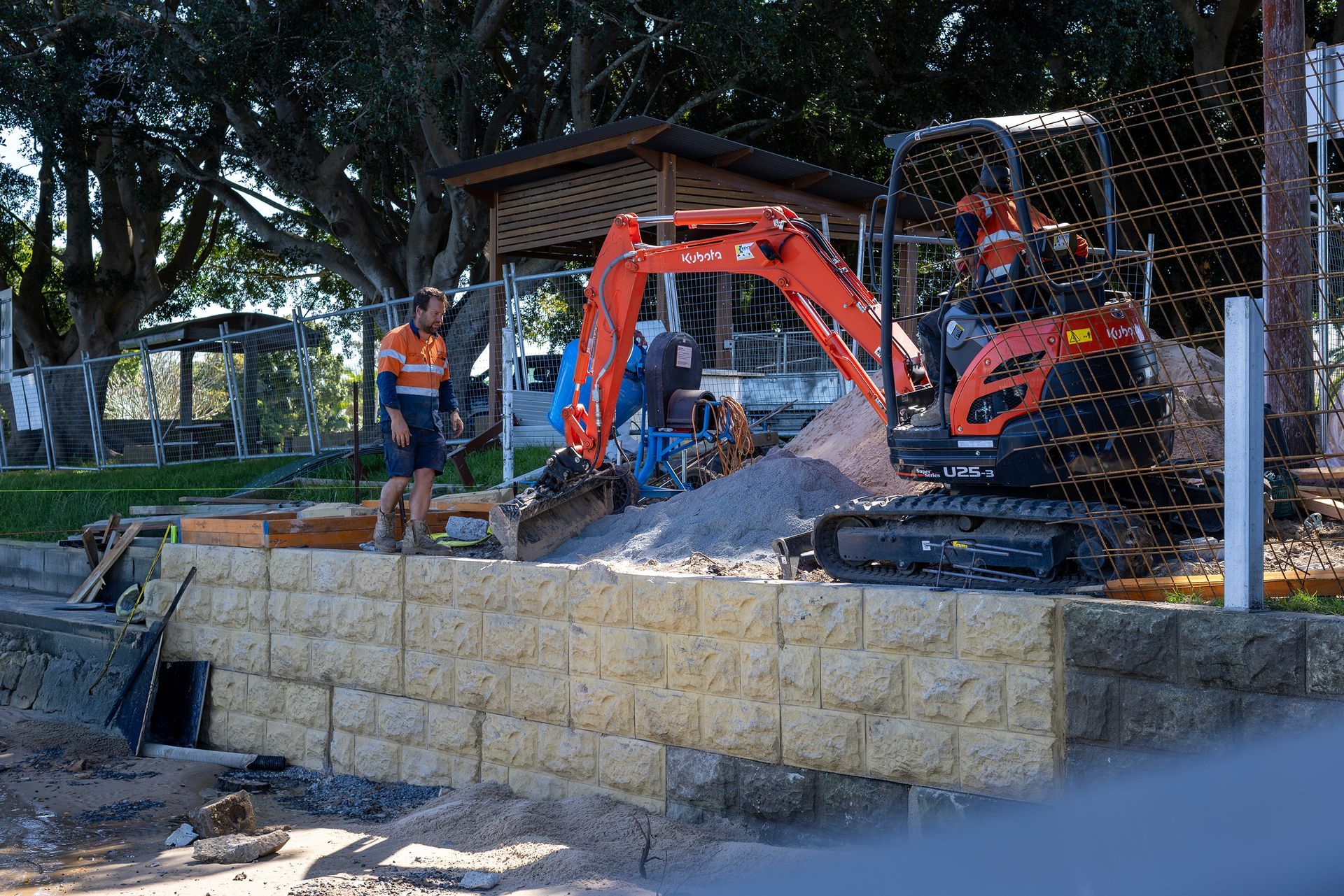 An Orange Excavator Sits on A Construction Site — M&J Marine Services in Medowie, NSW