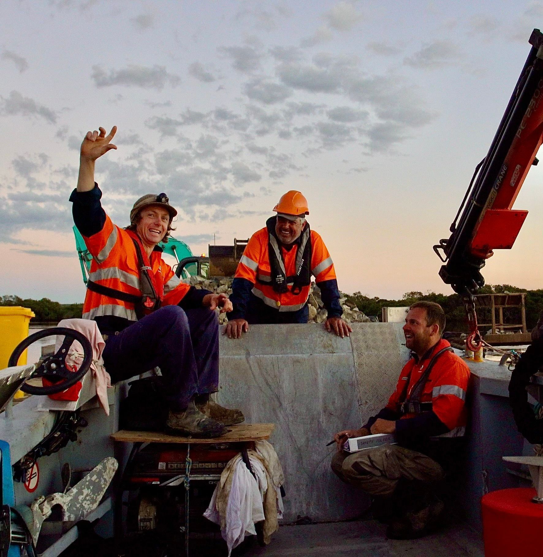 Three Construction Workers on A Boat, Wearing Safety Vests and Helmets — M&J Marine Services in Medowie, NSW
