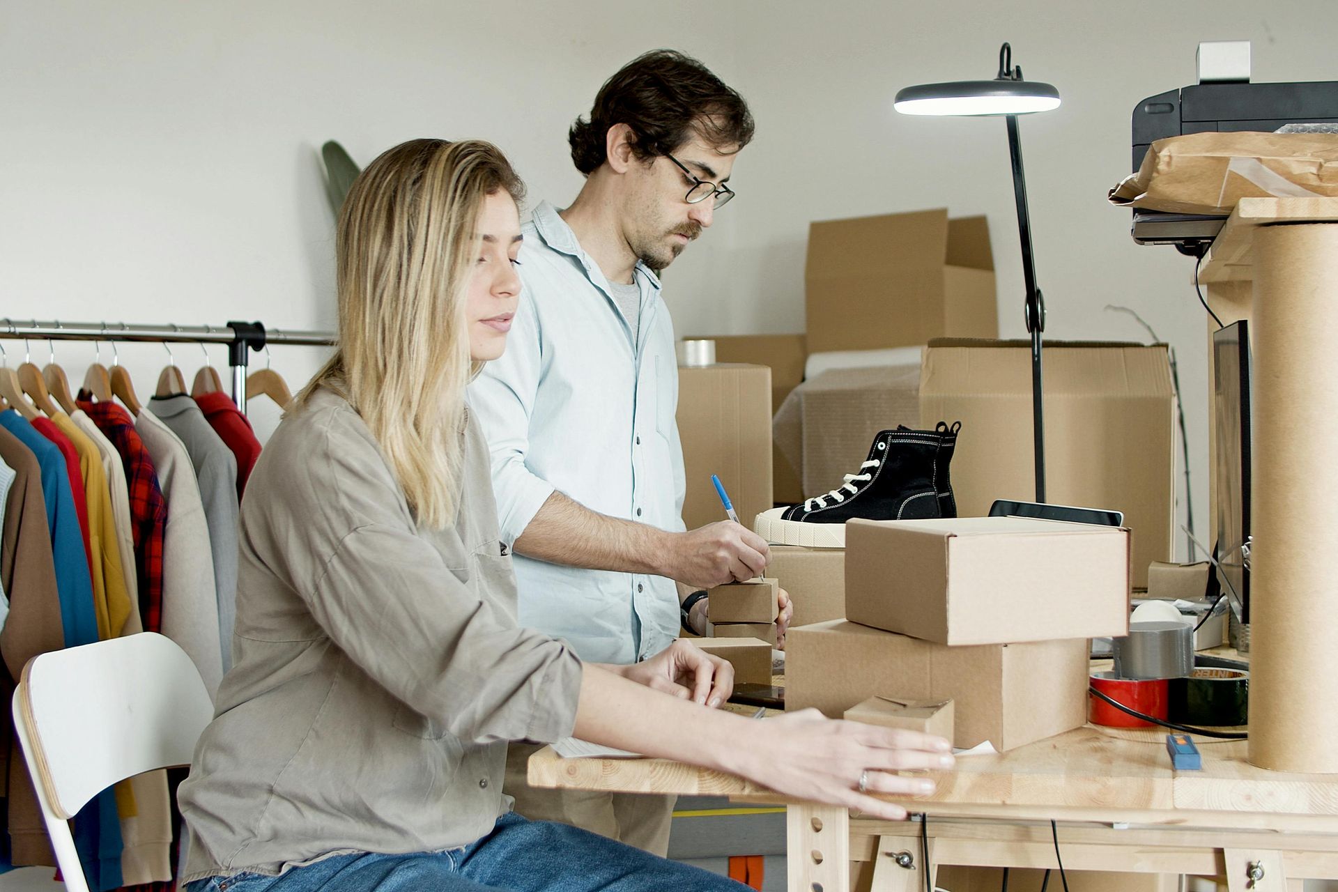 couple packing and labeling boxes for a move