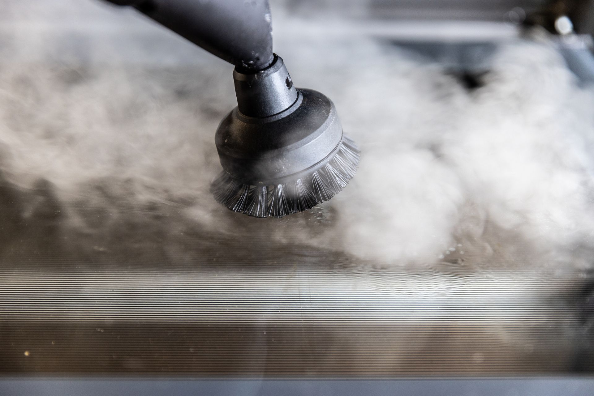 View of a steam cleaning tool disinfecting a a surface.