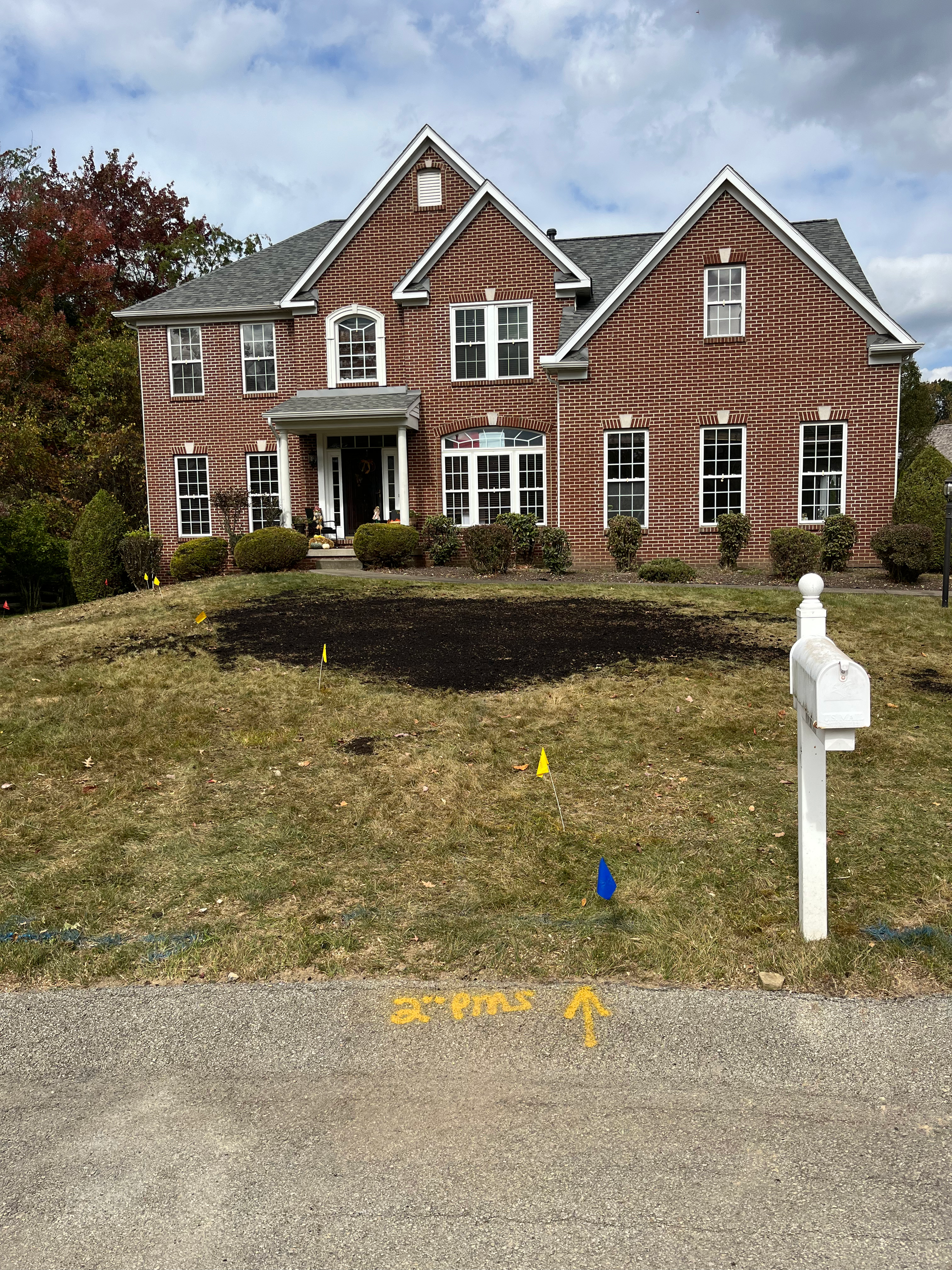 a large brick house with a mailbox in front of it .