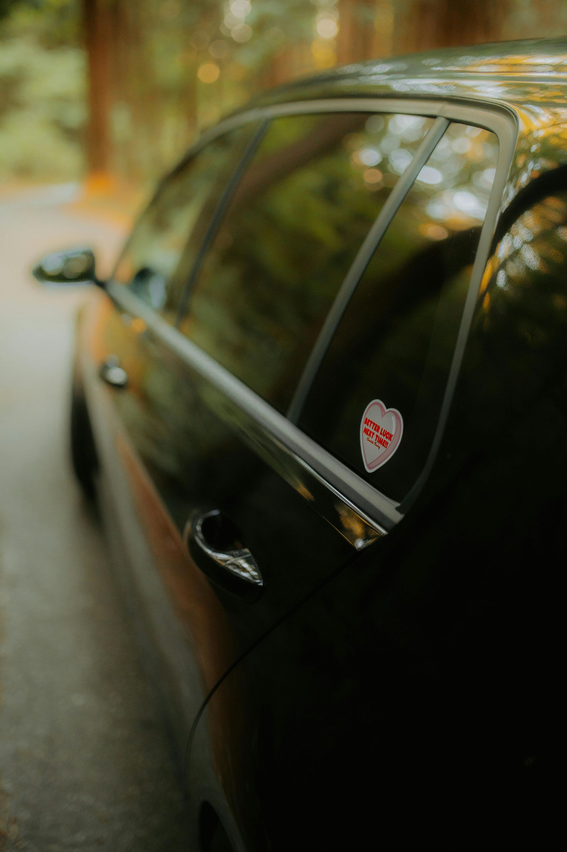 A close up of a car with a sticker on the window.